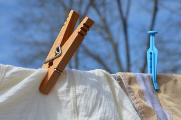 both wood clothespin and plastic clothes peg