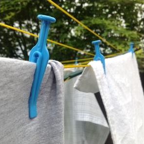 Clothes pegs hanging a shirt and towel